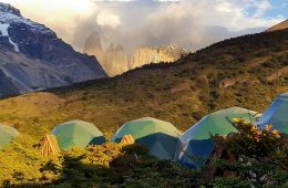 Tents sit in front of jagged spires in Patagonia.