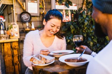 A traveling couple dines at sunset.