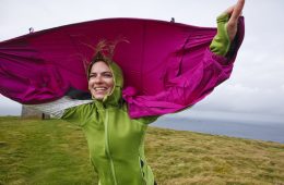 A woman enjoys the windy Ireland weather.
