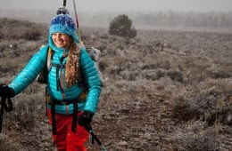 The ground is dirt, not snow, but a skier heads out anyway.