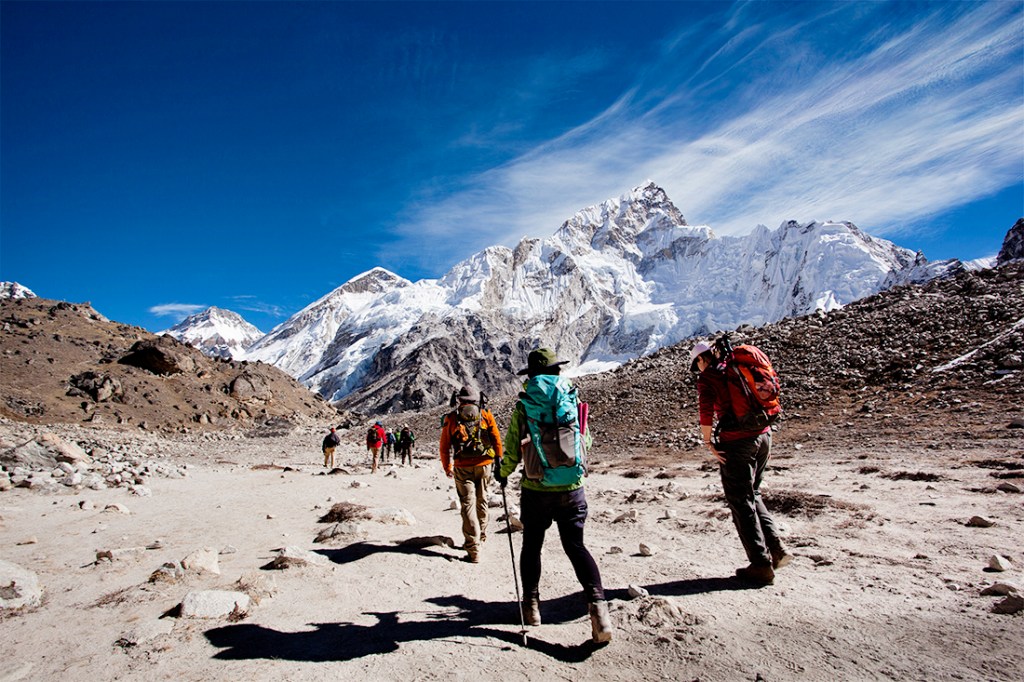 Nuptse and Lhotse rise up to meet a hiking group as they near Everest Base Camp.