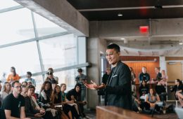 Danny Kim at the front of a room leading a workshop.