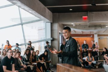 Danny Kim at the front of a room leading a workshop.