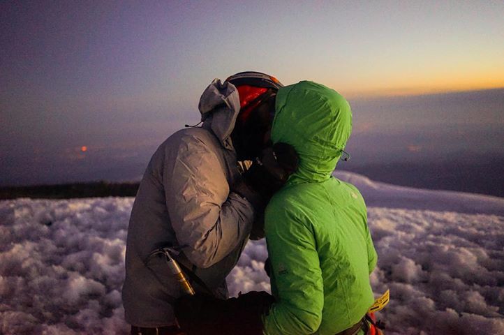 Couple kisses at the top of Mount Rainier.