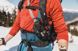A skier wearing an avalanche beacon.