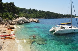Travelers enjoy the sun, sand and aquamarine sea of a Croatian island.