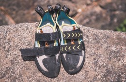 A pair of climbing shoes rest on a rock.