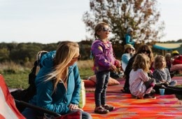 A child staring into the distance with sunglasses on