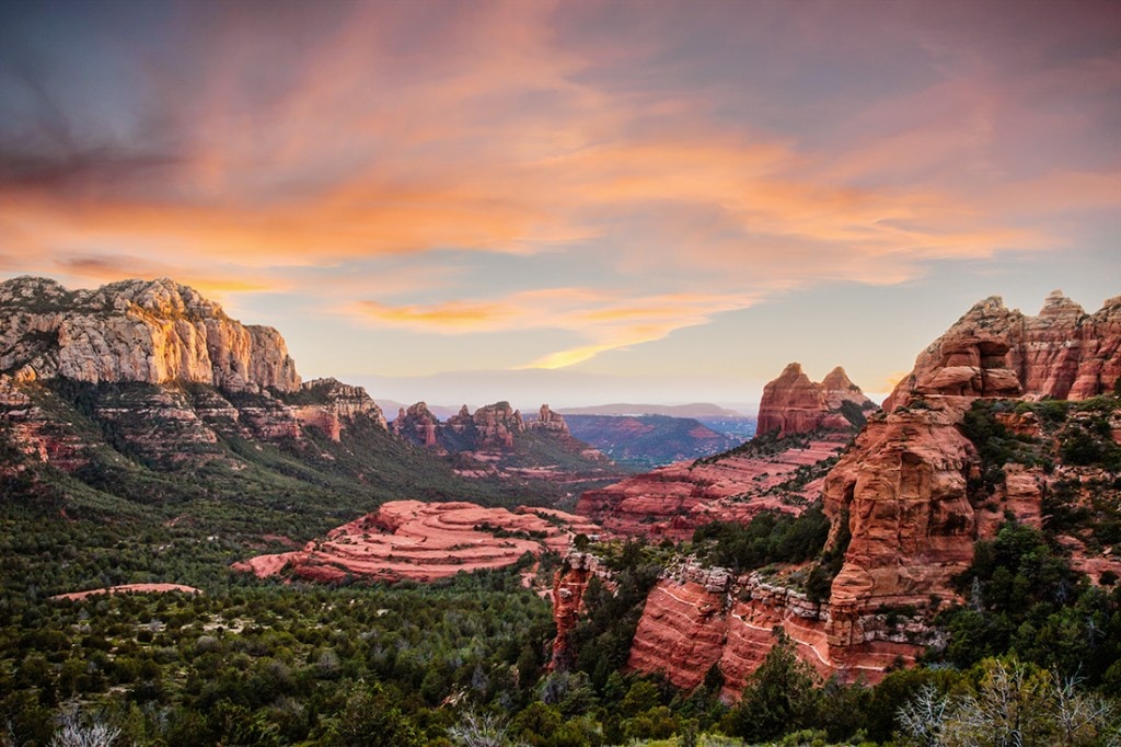 A red rock sunset near Sedona, Arizona, ripples across the skyline.