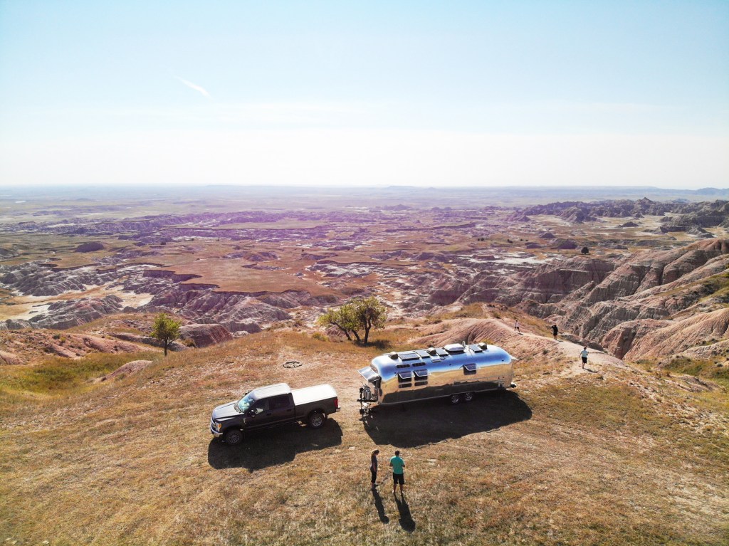 An airstream parked among red rock canyons 