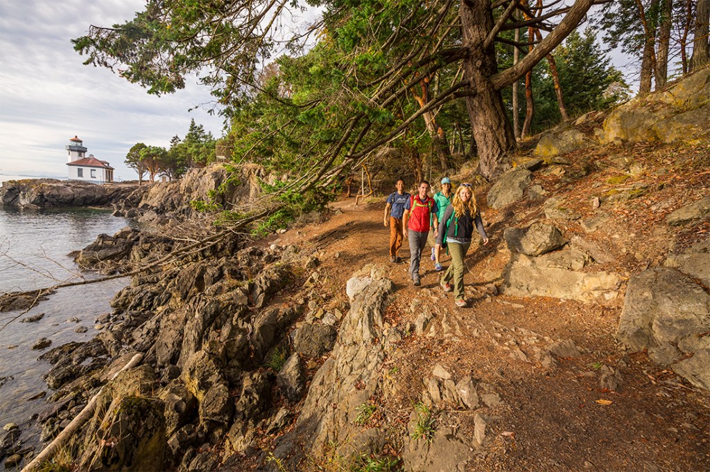 Hikers enjoy the walking near Lime Kiln Lighthouse on San Juan Island. 