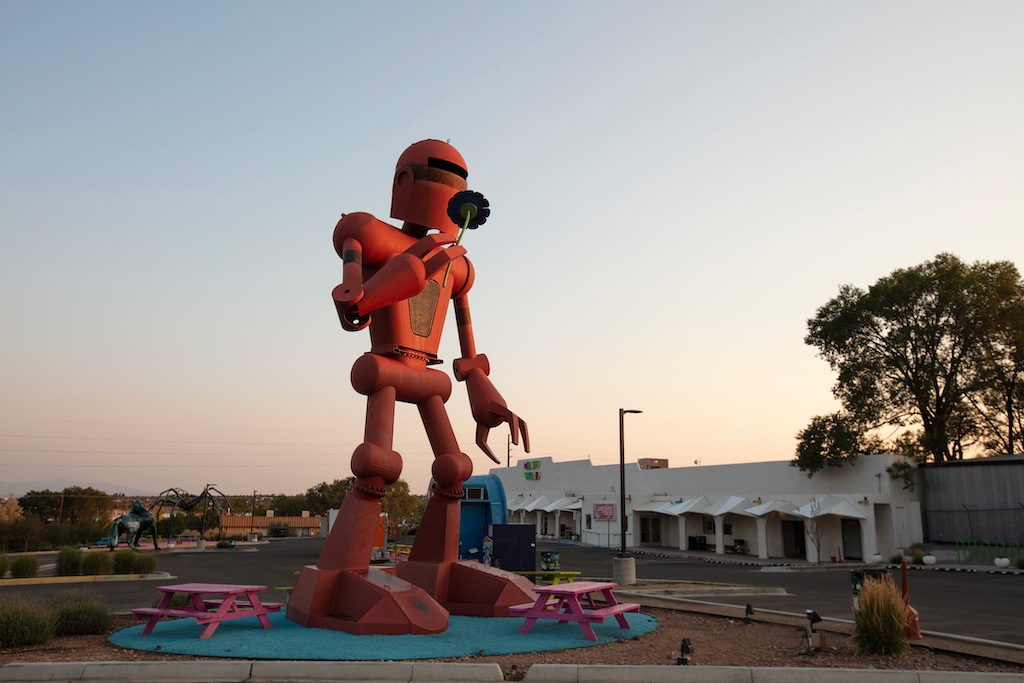 A large robot statue stands outside of The exterior of Meow Wolf's House of Eternal Return in Santa Fe, New Mexico.