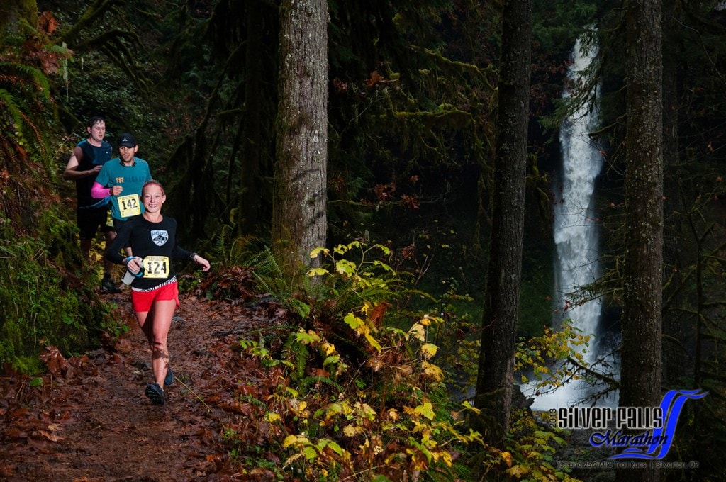 Runners enjoy views of the waterfall in this Oregon trail run.