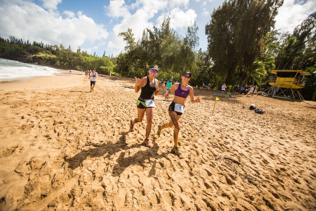 Runners jog along the beach in the Kapalua 10K in Hawaii.