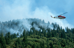 A helicopter drops water onto the forest fires in the Mendocino National Forest, California.