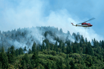 A helicopter drops water onto the forest fires in the Mendocino National Forest, California.