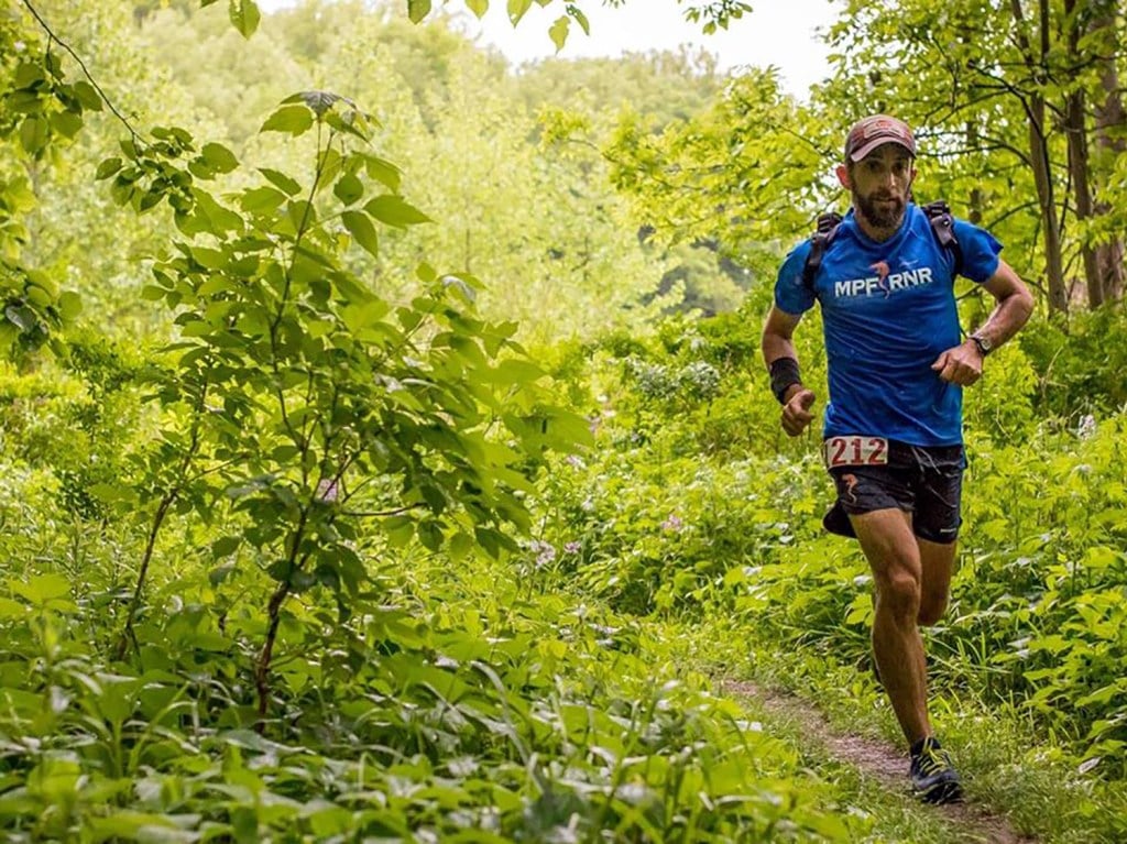 Podcast host Jason Friedman listens to podcasts while running on a trail.