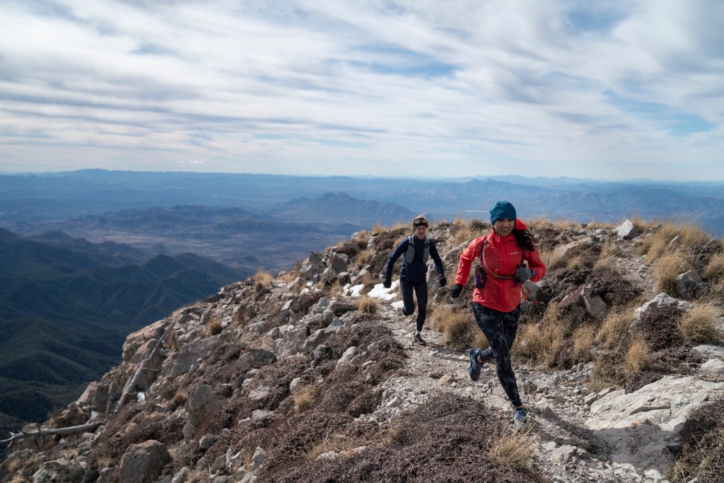 Clare Gallagher and Lydia Jennings run up one of the highest peaks in Arizona. 