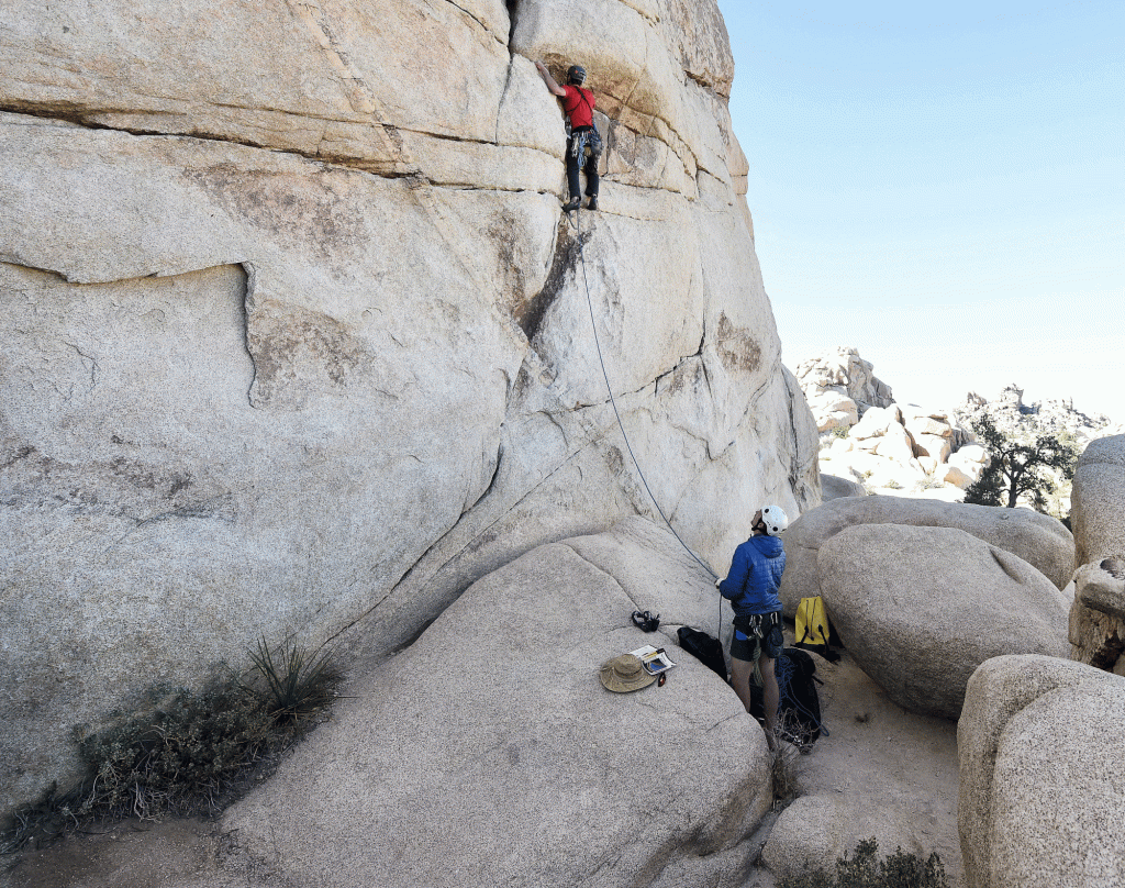 Justin Blevins, from East Sound, Washington, climbs a rock face in the Hidden Valley campground in Joshua Tree National Park Thursday as his friend Noah Waldron assists. Despite the partial federal shutdown Joshua Tree National Park remained open Thursday, January 10, 2019. The park has minimal staffing and campgrounds are now open.
