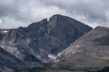 A brooding Longs Peak under grey clouds.