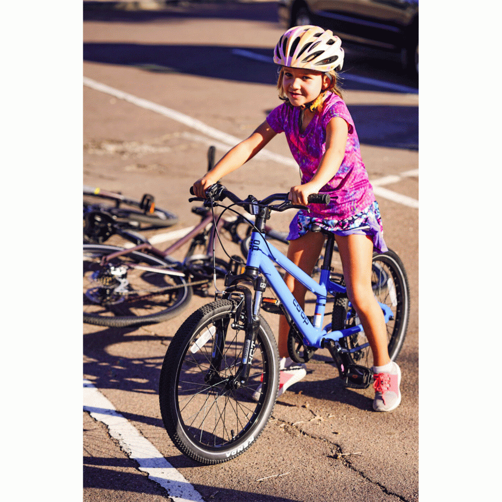 A little girl pauses during a bike ride
