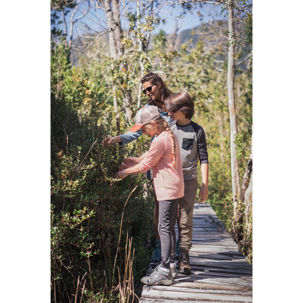 A mom and her kids investigate nature on a path