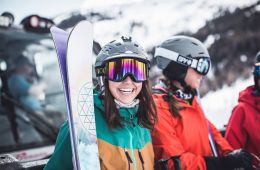 a smiling skier wearing goggles