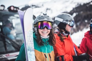 a smiling skier wearing goggles