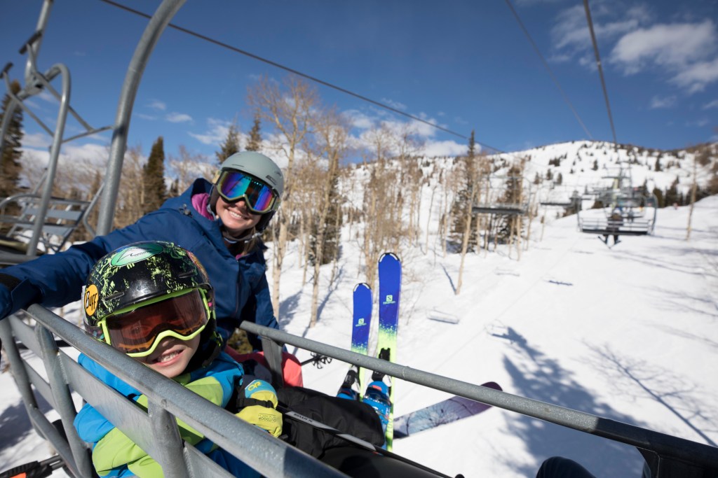A family rides a chairlift at Grand Targhee. 