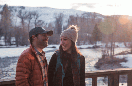 Two people looking at each other fondly in the outdoors