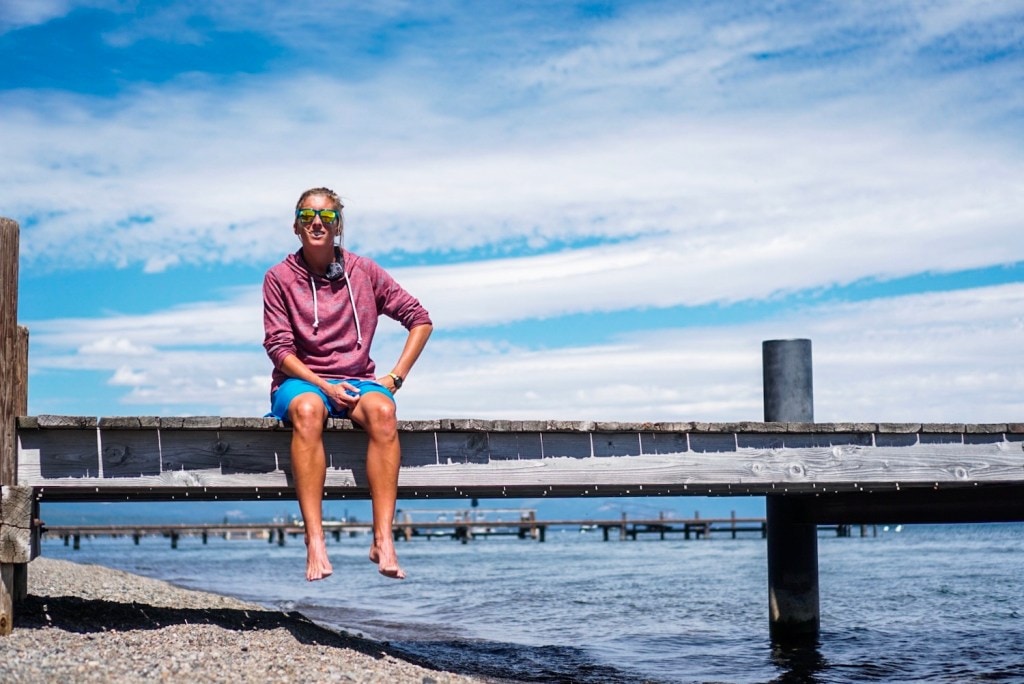 Courtney Dauwalter sits on a dock overlooking Lake Tahoe.