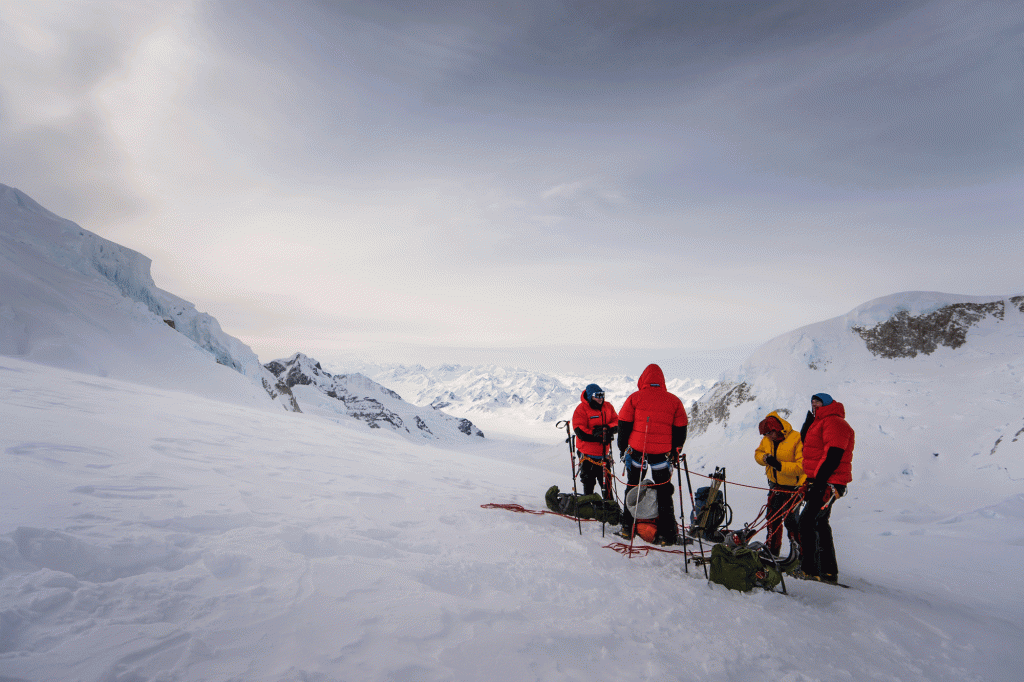 Mountaineers stop for a break on a snowy face