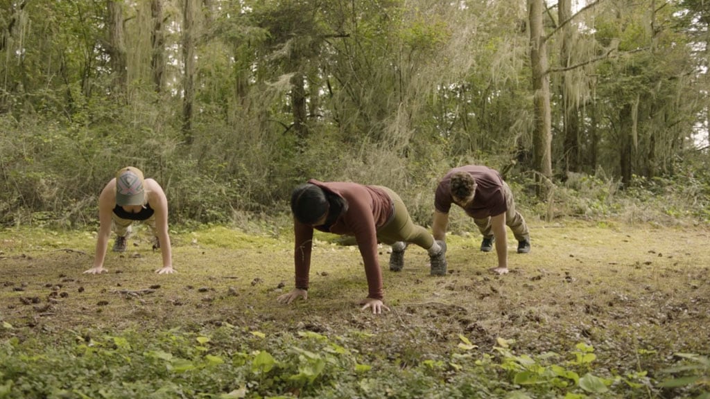 CorePower Yoga instructors hold high plank pose