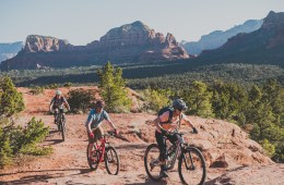 Three people ride mountain bikes in Sedona.