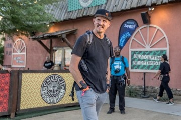 Mick Ebeling standing in front of the camera and smiling.