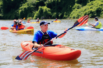 A photo of Senator Rob Portman paddling down a river