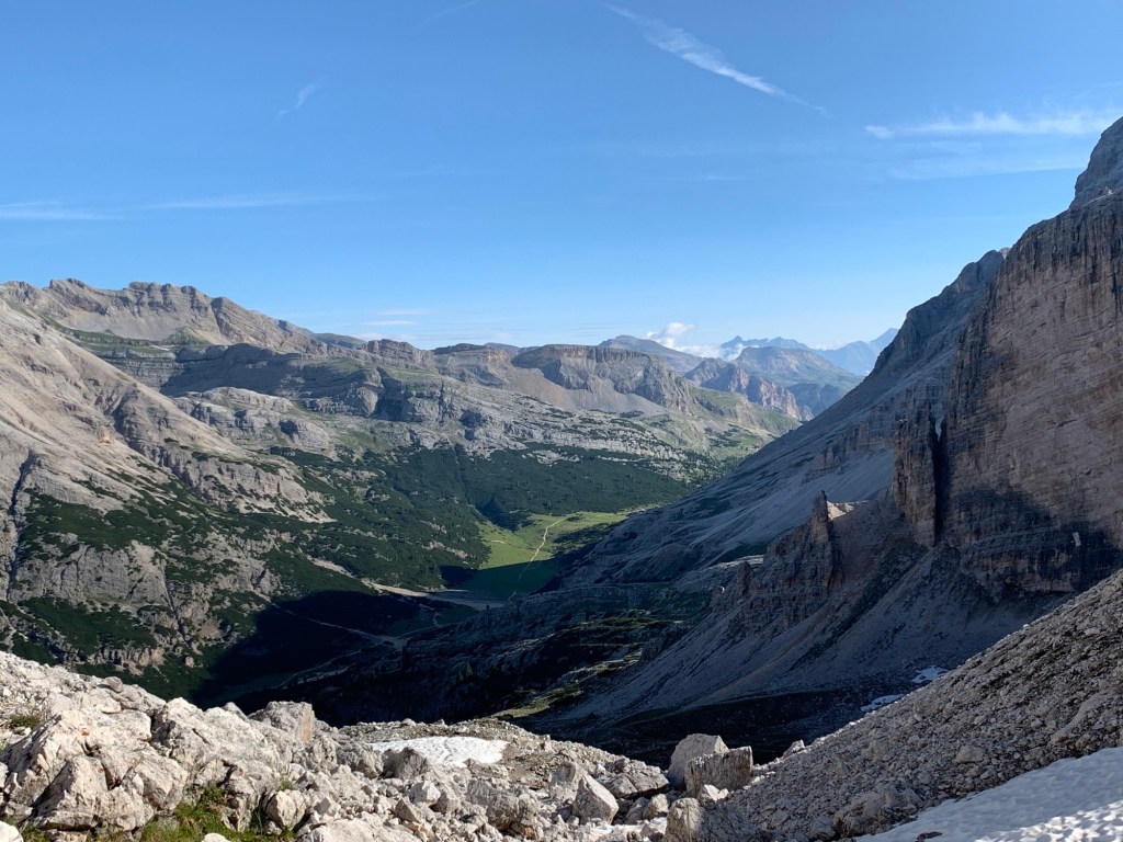 The craggy limestone walls are cut by a thin ribbon of green of the valley.