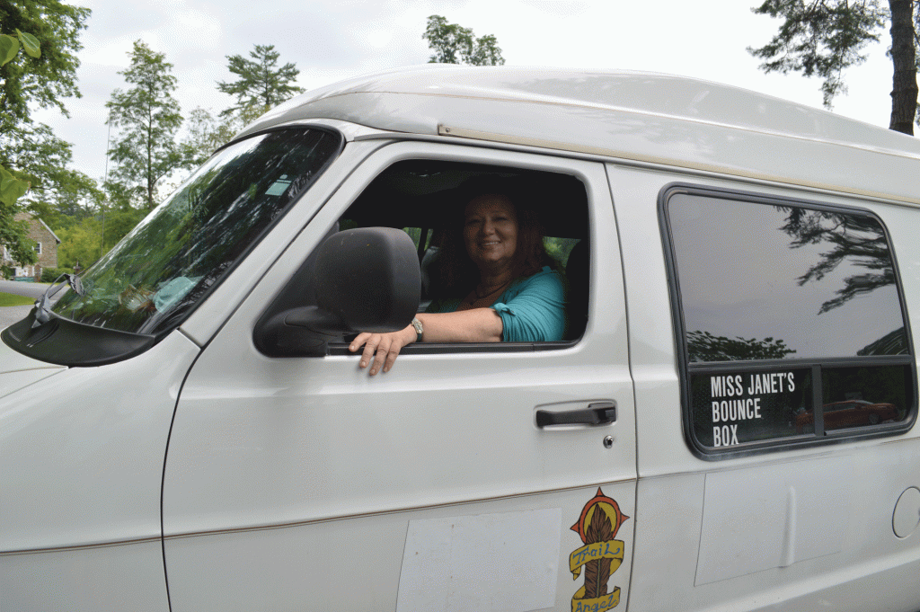 Miss Janet poses inside her white van
