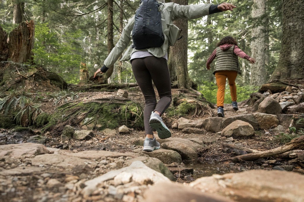 Two people hiking on rocks.