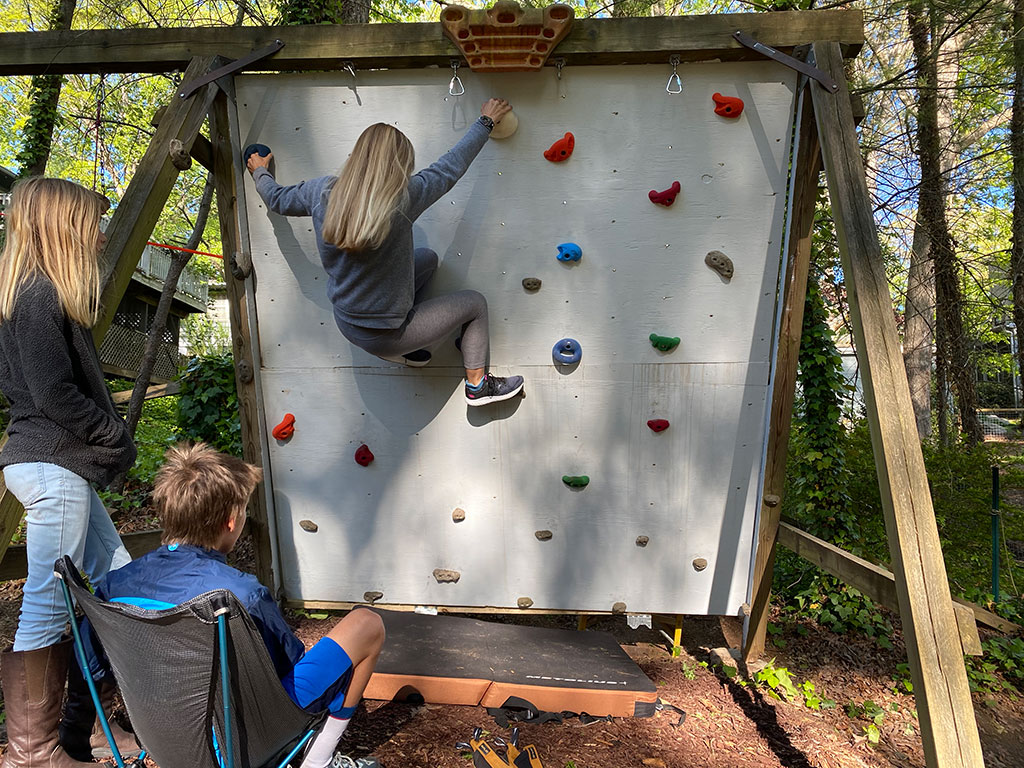 Young climber on at-home climbing wall