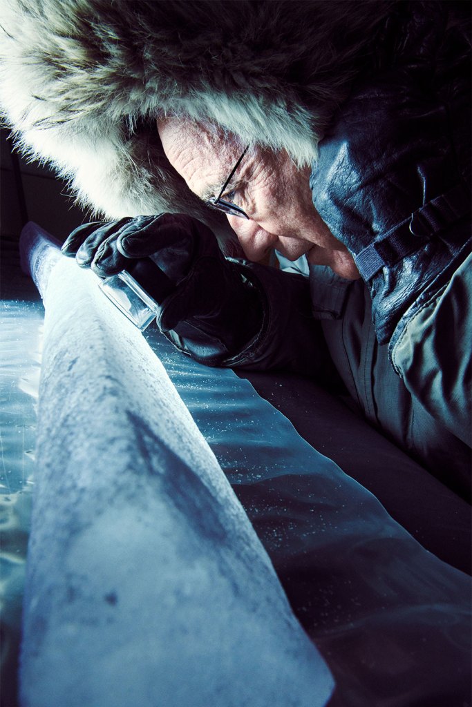 Thompson inspects an ice core from Tibet’s Puruogangri ice cap.