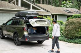 Woman packing up her Subaru in her driveway.