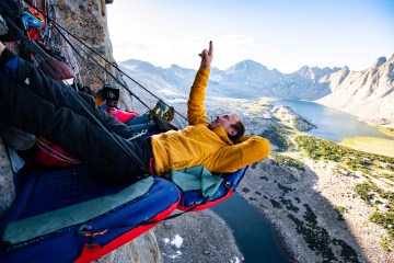 Jesse Huey and Maury Birdwell relax at the hanging portaledge camp high on Mt. Hooker, Wind River Range, Wyoming, USA. In August of 2019 the pair finished their multi-year project Gambling In The Winds (5.12+)