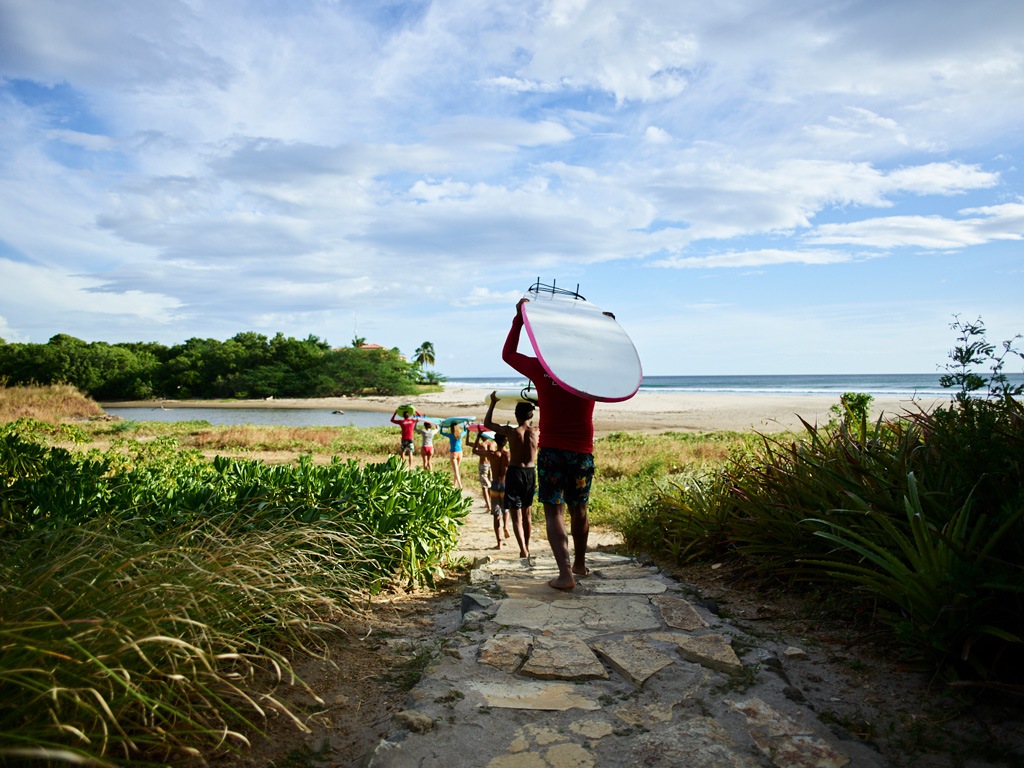 Surfers head out for a lesson at Rancho Santana, in Popoyo. 
