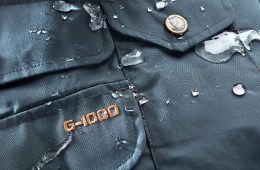 An up close image of a Fjallraven jacket with water beading on it.