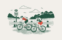 Two cyclists pedaling along a highway in Florida
