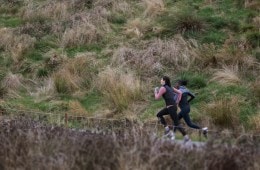 Two runners sprint uphill