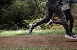 Two runners sprint down a trail in On shoes