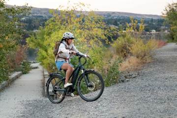 Person riding e-bike up hill