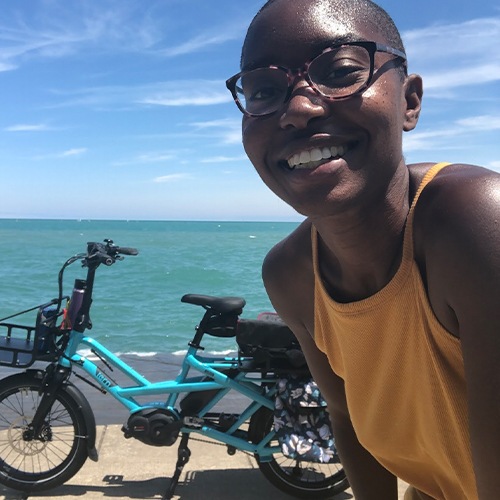 Woman in front of her blue e-bike